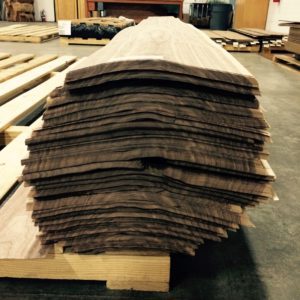 American Walnut presented in its log form with bundles stakced in order to form a cylindrical stack.